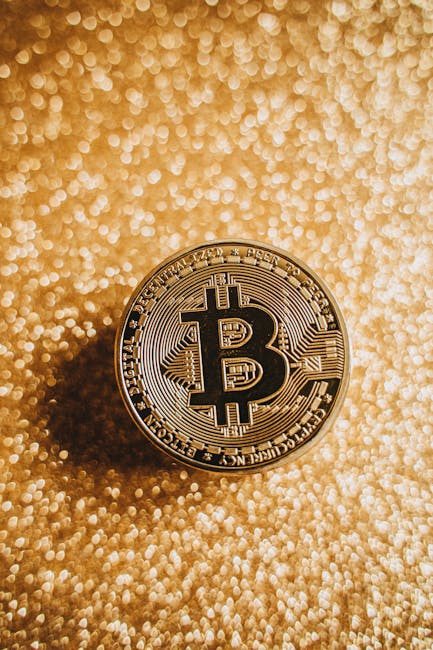 A close-up of a Bitcoin coin against a shimmering gold background, symbolizing digital currency and finance.